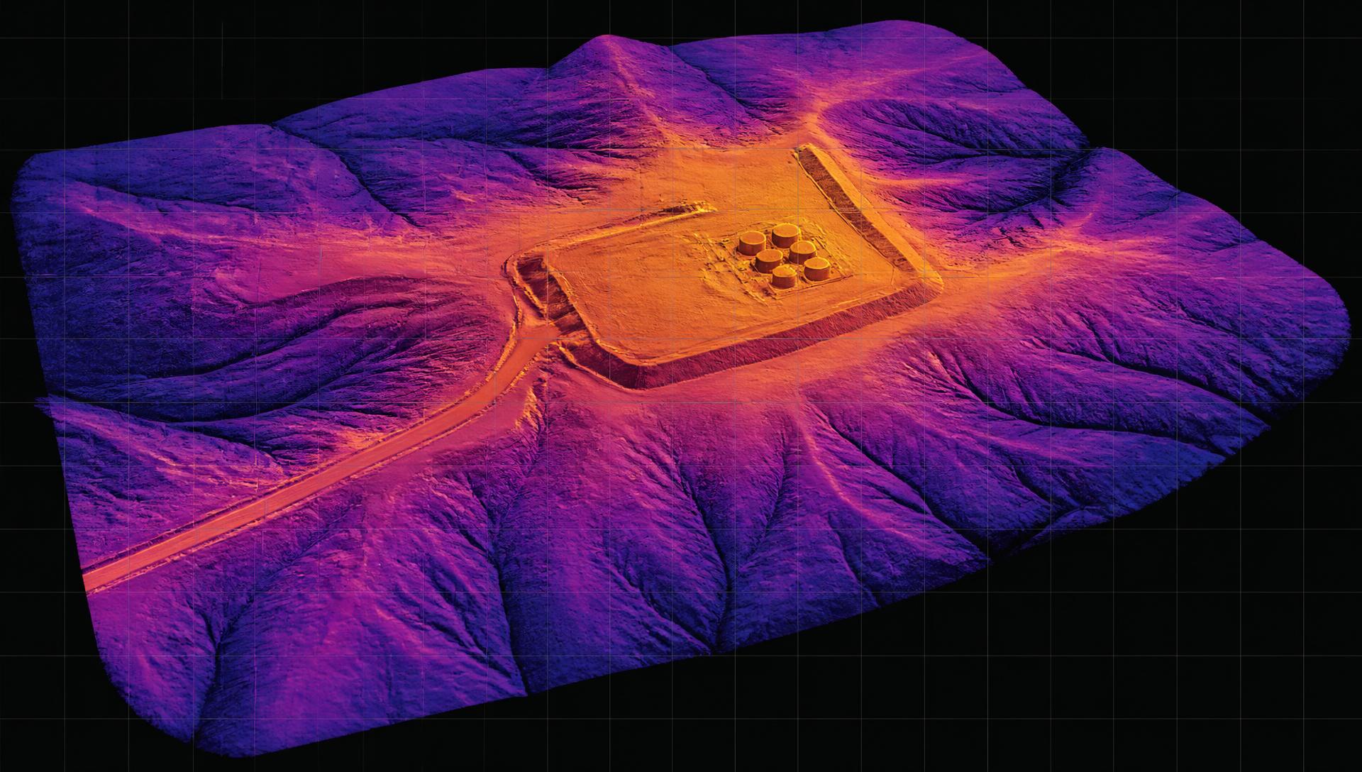 False-color lidar digital elevation model of an oil lease showing pad cut-and-fill, berms and drainage